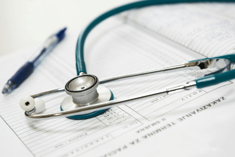 Stethoscope on Medical Paperwork Stethoscope resting on medical paperwork with a pen, representing healthcare assessment and diagnosis.